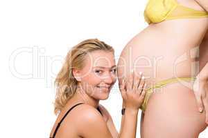 Smiling woman and belly of pregnant girlfriend