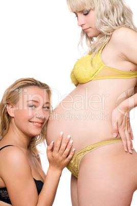 Pregnant woman with the smiling girlfriend. Isolated