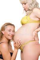 Pregnant woman with the smiling girlfriend. Isolated