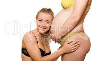 Happy woman and belly of pregnant girlfriend