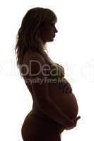 Silhouette of a pregnant young woman