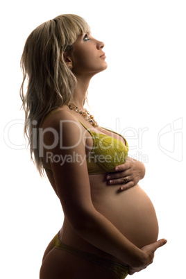 Pregnant young woman in yellow lingerie. Isolated
