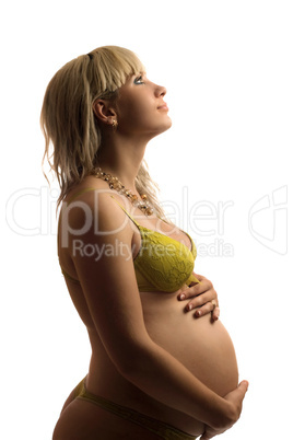 Happy pregnant young woman in yellow lingerie