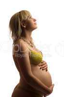 Happy pregnant young woman in yellow lingerie
