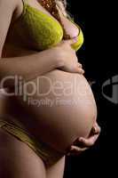 Belly of a pregnant young woman. Isolated