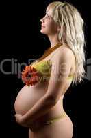 Pregnant young blonde with red flower. Isolated