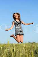 attractive girl jumping in field