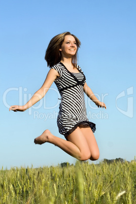 pretty girl jumping in field