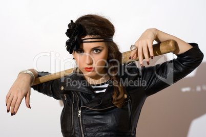 Serious young woman with a bat