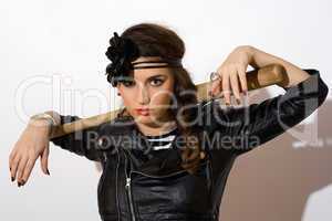 Serious young woman with a bat