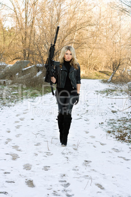 Beautiful young blonde with a gun