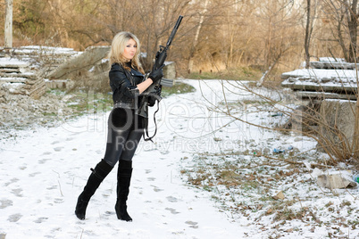 Beautiful young woman with a gun
