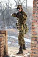 Soldier near wall with a gun