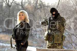 Soldier and blonde armed with rifles
