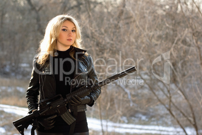 attractive young blonde with a gun