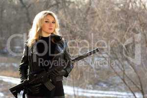 attractive young blonde with a gun