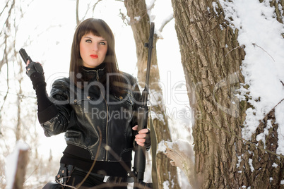 young woman with a pistol and rifle