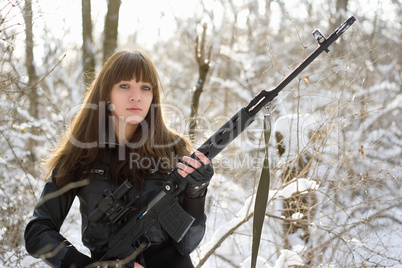 Armed young lady with a gun