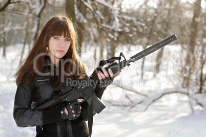 Beautiful armed girl in the forest