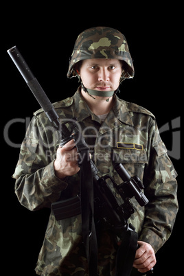 Armed soldier grasping m16