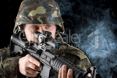 Soldier with the smoking gun. Closeup