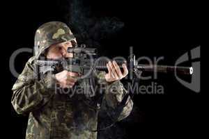 Alerted soldier keeping a smoking gun