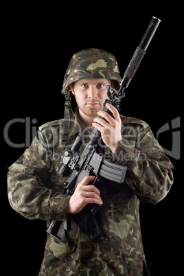 Alerted soldier raised m16 in studio