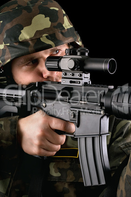 Armed soldier taking aim