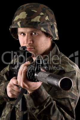 Watchful soldier aiming  m16 in studio