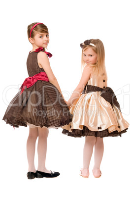 Two little girls in a dress. Isolated