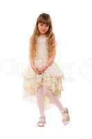 Cute little girl in a beige dress