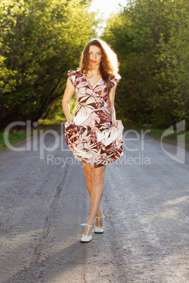 Beautiful woman walking on the road