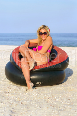 Beautiful girl sitting in an inflatable chair