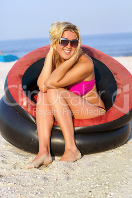 Cheerful girl sitting in an inflatable chair