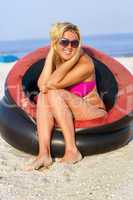 Cheerful girl sitting in an inflatable chair