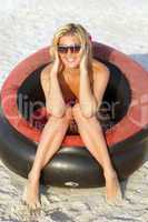 Happy girl sitting in an inflatable chair