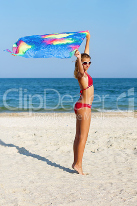 Beautiful teen girl standing on the beach