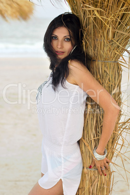 Beautiful young brunette on a beach