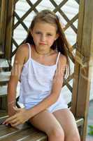 girl sitting on a wooden bench