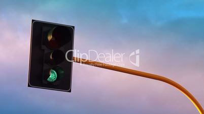 Traffic light with colorful sky timelapse on a background