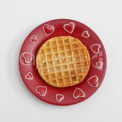 Waffle on red plate with hearts