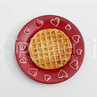 Waffle on red plate with hearts