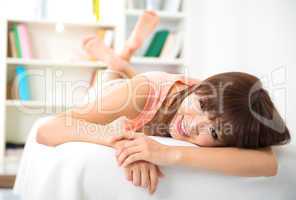 Asian woman relaxing on sofa