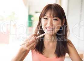 Asian woman eating