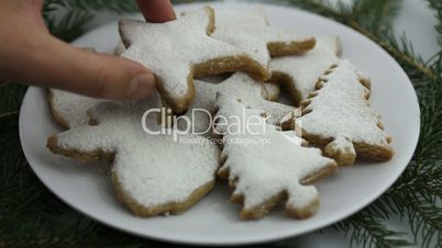 Hands of a woman placing cookie on a dish