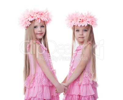 Two beautiful little girls in pink dresses