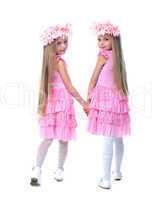 Little girls in pink dresses