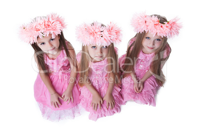 Three beautiful little girls with pink wreaths