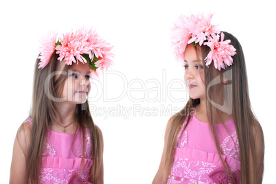 Little girls in pink dresses with garland isolated