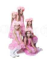 Pretty little girls in pink dresses and wreaths